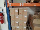 boxes are stacked on a shelf in a warehouse with a fire extinguisor nearby