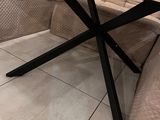 a couch and a table in a room with white tile flooring