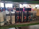 many different types of spray paint on a shelf