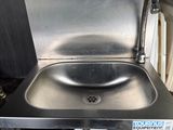 a stainless steel sink with a faucet on the side of it