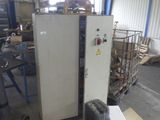 a machine that is sitting in a warehouse with other machines in the background