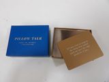 a blue box with a card inside of it on a white surface