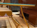 a table with a glass top sitting on a wooden floor