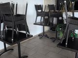tables and chairs in a room with a television on the wall