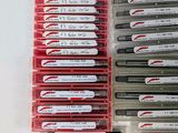 a lot of pens that are sitting on a table