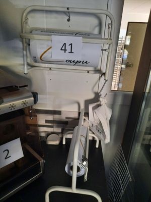 a toilet in a room with a sign on the wall