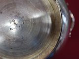a close up view of a metal object with a red background