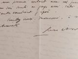 an open book with a handwritten letter on it sitting on top of a table