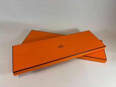 two orange boxes are stacked on top of each other on a white surface