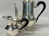 an image of a silver coffee pot and two silver cups