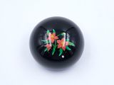an image of a close up of a black ball with flowers on it