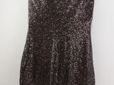the back of a brown dress hanging on a hanger