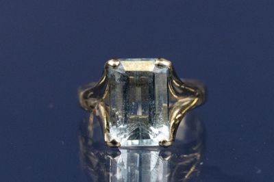 a ring that has a green stone in it