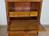 a wooden cabinet with two drawers and a drawer underneath it