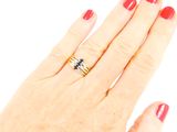 a woman ' s hand with a red manicure and a gold ring