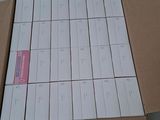 a cardboard box with a bunch of white cards in it