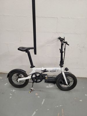 un scooter blanc avec une selle noire et un guidon noir