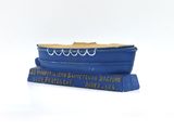 a blue boat that is sitting on top of a book
