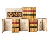 several books are stacked on top of each other on a white surface