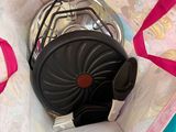 a bag with a fan inside of it on the floor