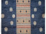 a blue and orange rug with circles and crosses on it