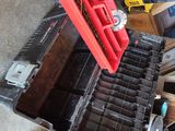 a red tool box with tools in it sitting on the floor