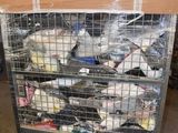 a metal cart with many items in it in a warehouse