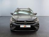 the front view of a grey volkswagen suv parked in a showroom