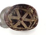 a helmet that has a wheel on it on a white surface