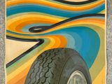 a poster of a tire on the side of a building