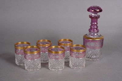 six glasses and a decanter sitting on a table