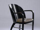 an image of a black chair with a leather seat on a grey background