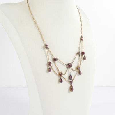 a close up of a mannequin with a necklace on it