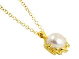 a close up of a necklace with a pearl on a chain