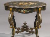 a small table with a bird motif on the top
