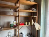 a room with a shelf and a window in it
