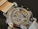 a close up of a watch on a black surface