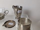 a glass table with silverware on it and a cup on the table