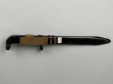 a close up of a pen with a wooden handle on a white surface