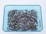 a blue container filled with lots of screws and nails