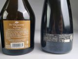 two bottles of wine sitting next to each other on a table