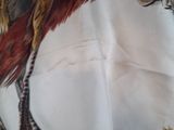 a picture of a picture of a bird on a table cloth