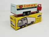 two toy trucks sitting on top of each other on a table