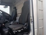 a white truck with a black seat and steering wheel