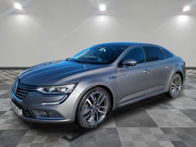 a grey car parked in a room with a checkered floor