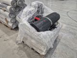 a pile of rolls of plastic sitting on top of a pallet
