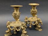 pair of antique brass candlesticks with cherenshes and cherenshes