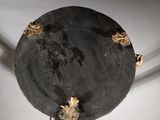 a close up of a black marble table with gold decorations on it