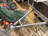 a green tarp on the ground next to a trailer