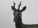 bronze sculpture of a deer with antlers on its head